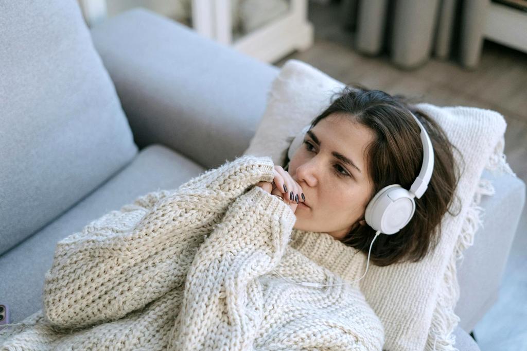 Cozy knitted cushions arranged on window bench filled with natural light
