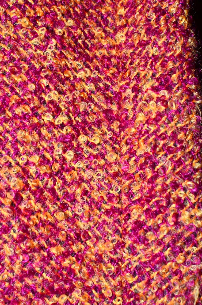 Workshop interior showing vintage knitting machines and yarn storage