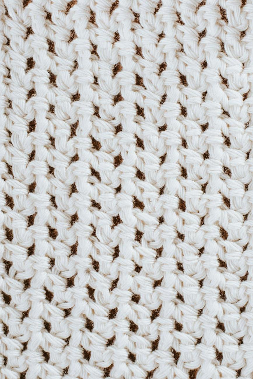 Workshop visitor Maria Santos enjoying hands-on knitting experience